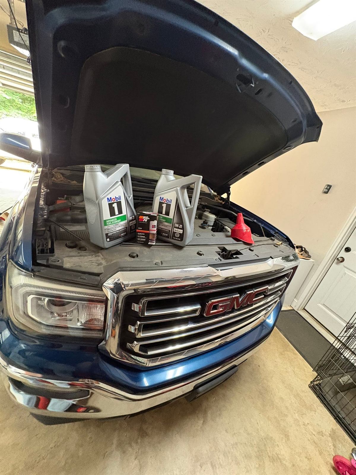 Oil and filter laid out for a service on a GMC Sierra